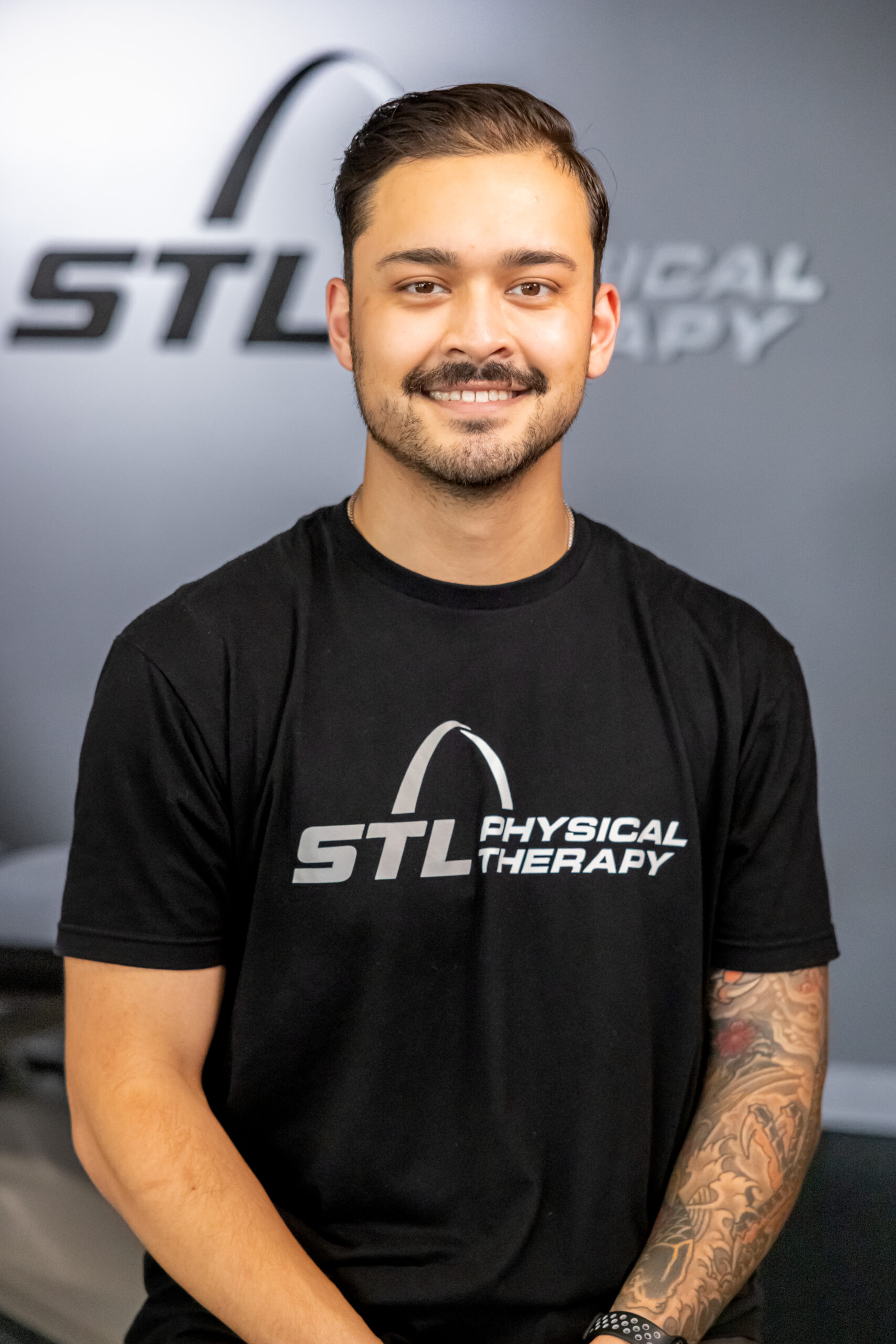 Smiling STL Physical Therapy physical therapist in a black team shirt